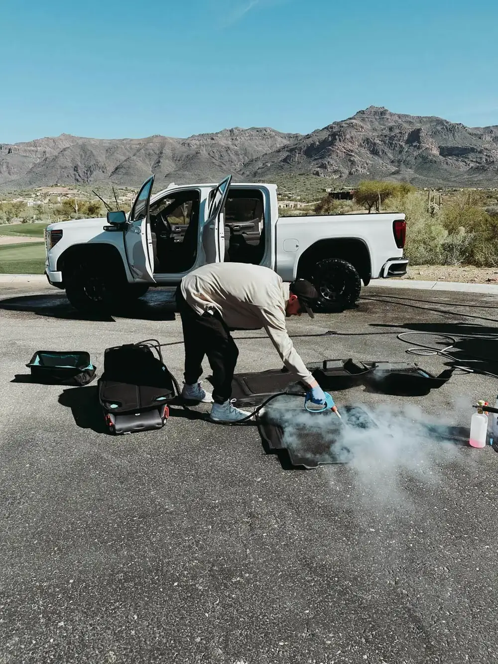 Technician using an industrial steam machine on a vehicle in Scottsdale, Arizona